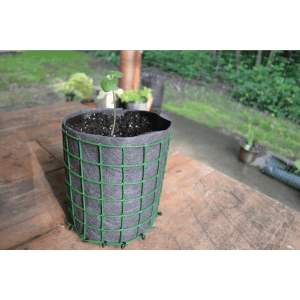 garden fence with landscape fabric liner as container pot with small plant on deck