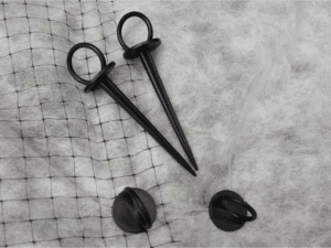 black plastic fabric pins on netting and landscape fabric landscape cloth landscape fabric pins